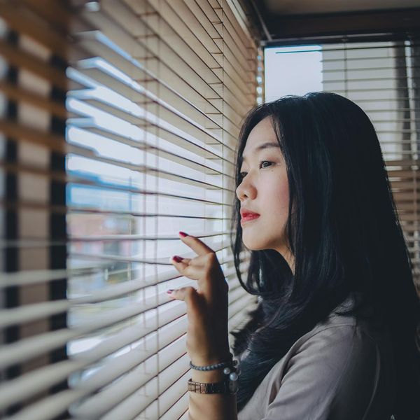 Close-up of a person meditating with calm expression.